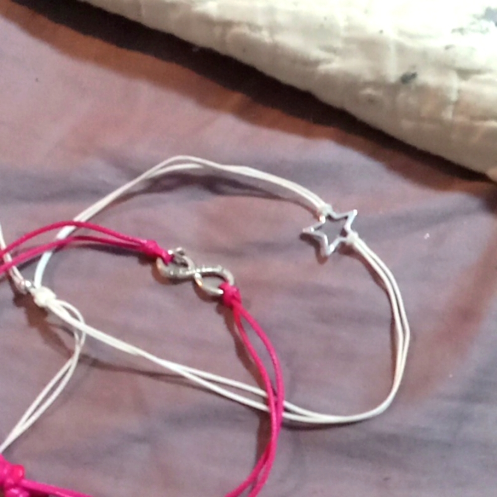 These are A. Silver and pink and white and silver. pair two friendship bracelets